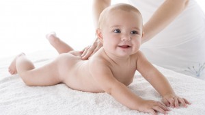 Mother massaging baby